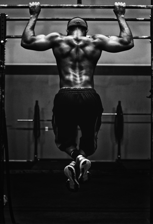 a man pulling up on a horizontal bar